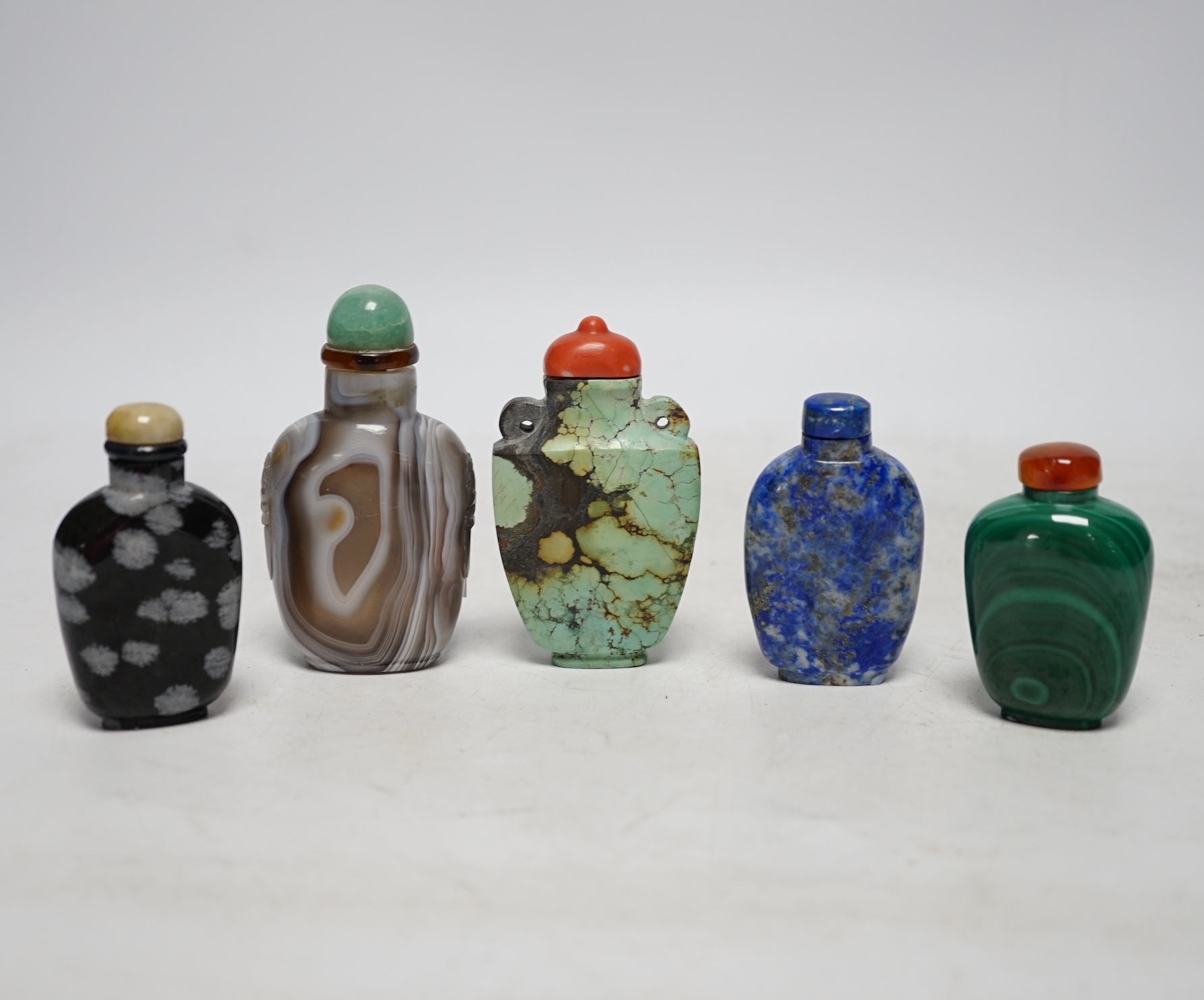 Five Chinese hardstone snuff bottles, 19th/20th century to include: black and grey marble, malachite, turquoise matrix, lapis lazuli and banded agate, largest 7.5cm high